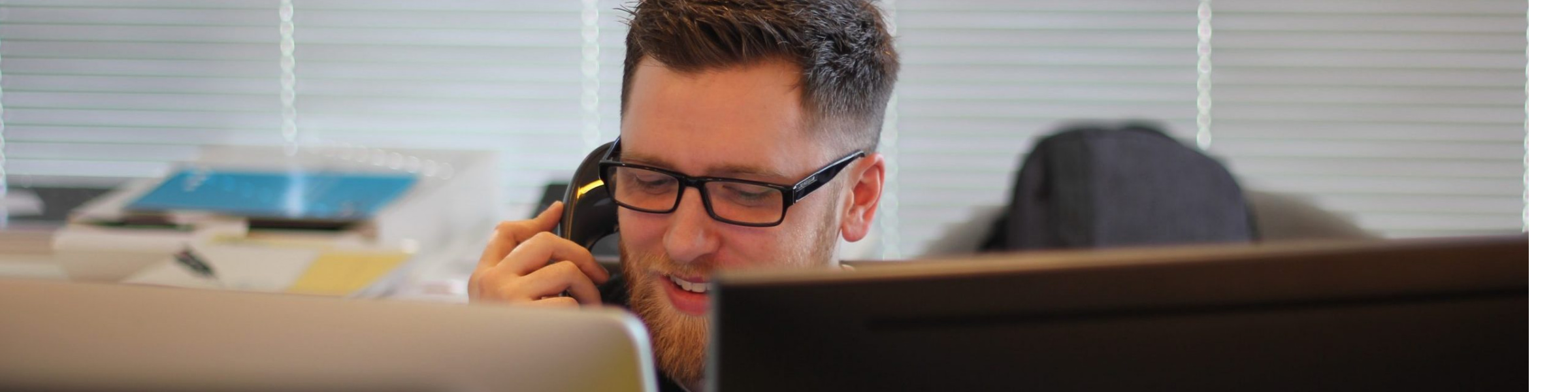 Male DfT Policy Professional answering a phonecall.