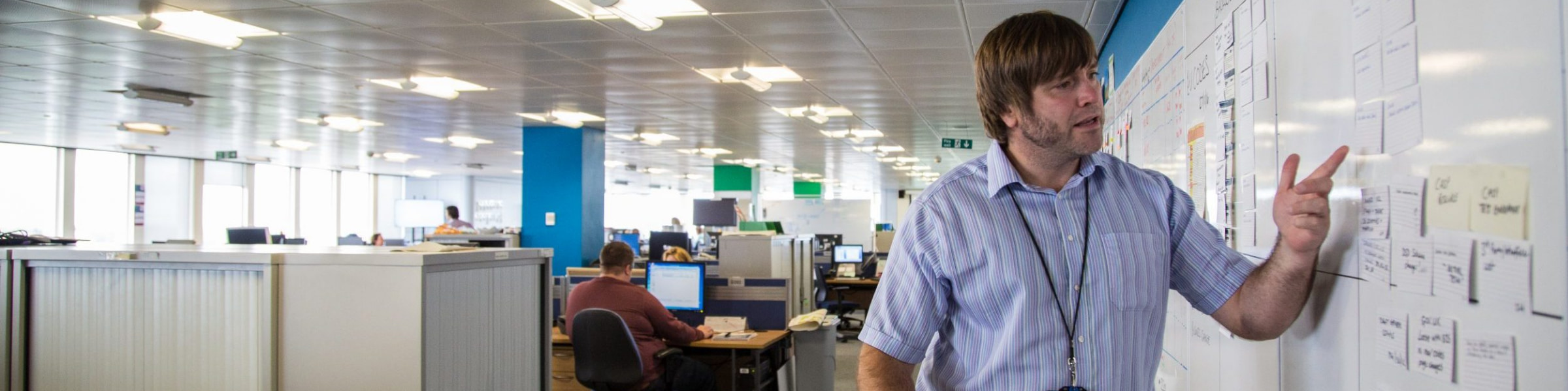 DfT Project Delivery professional using a whiteboard to present project plans.