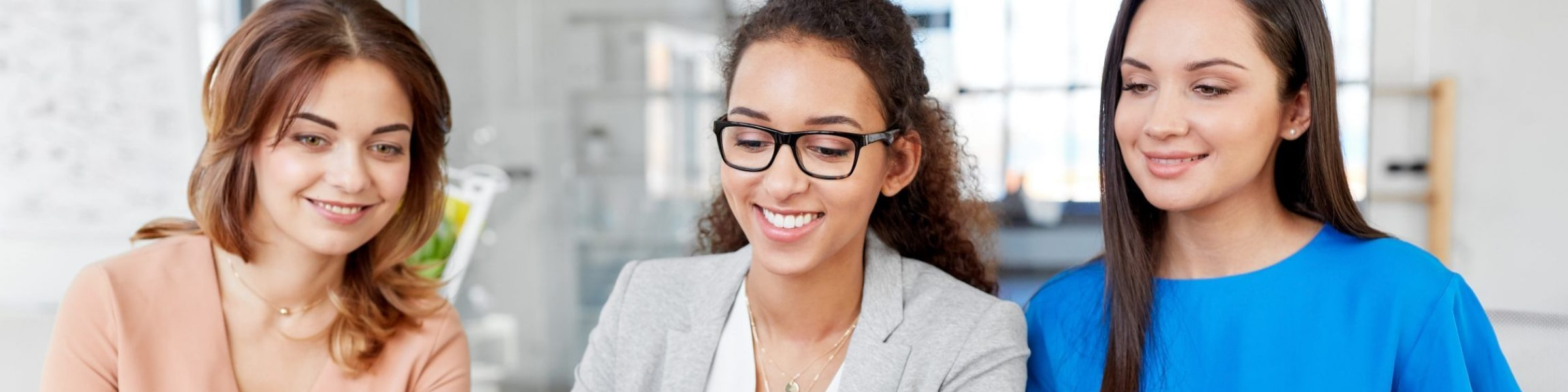 Female DfT staff with a tablet, PC and laptops.
