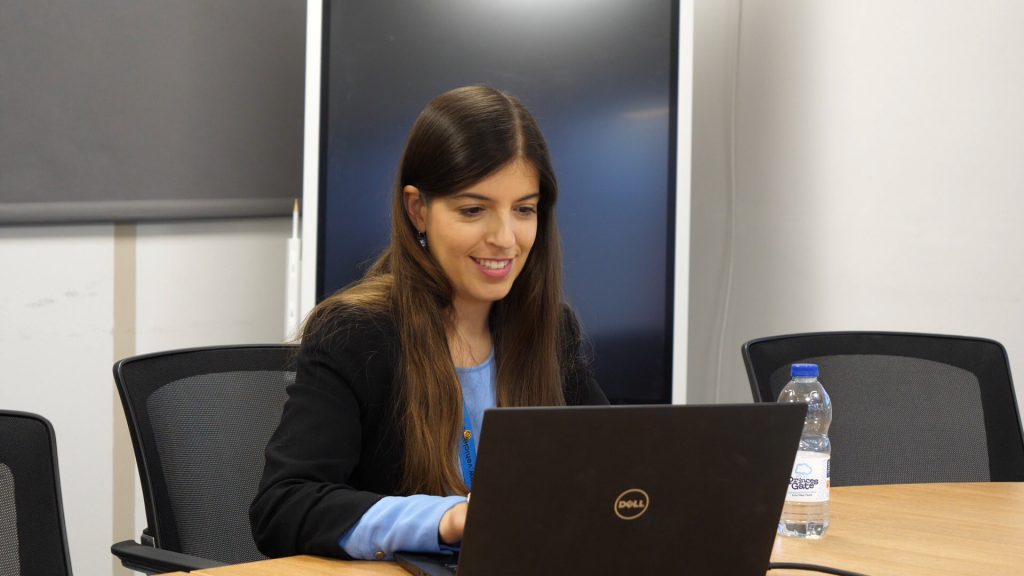 VCA staff member at work on her laptop in a meeting.