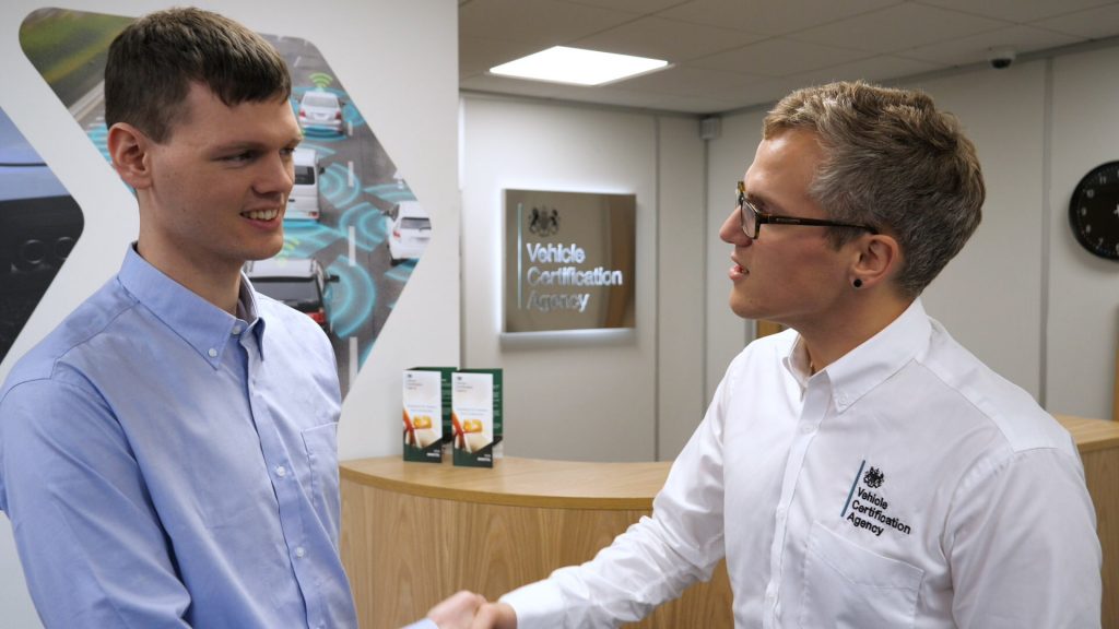 Male staff member at VCA shaking handing of young male.